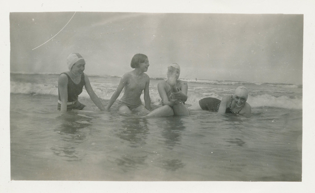 women playing in the surf