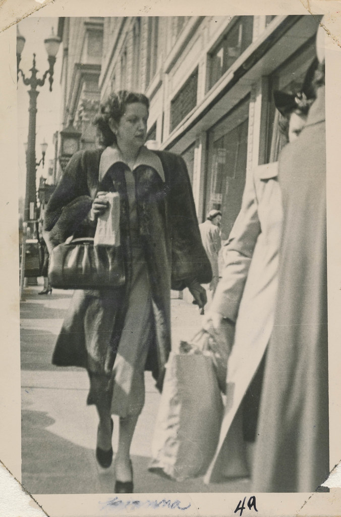 woman walking down a sidewalk